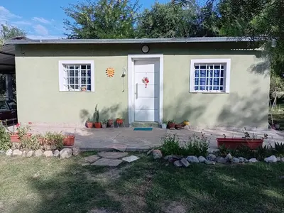 a house with a white door and windows at La Gringa in Villa Parque Siquiman