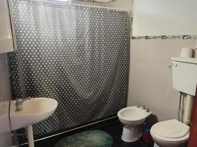 a bathroom with a shower and a toilet and a sink at La Gringa in Villa Parque Siquiman