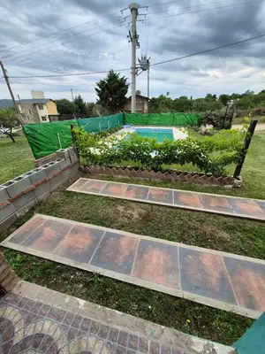 a backyard with a garden and a swimming pool at Cabaña La Zarzamora in La Estancia