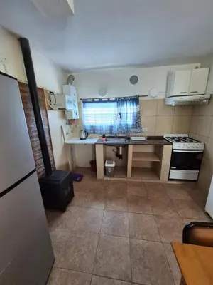 a small kitchen with a sink and a stove at Cabaña La Zarzamora in La Estancia