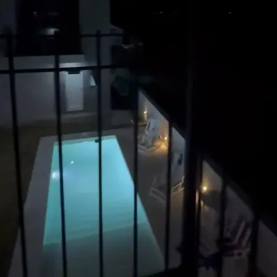 a view of a swimming pool in a room at night at cabañas RIALTO in Villa Amancay