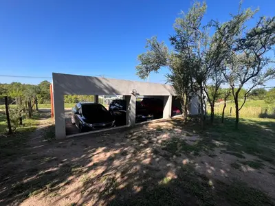 a car garage with a car parked in it at cabañas RIALTO in Villa Amancay
