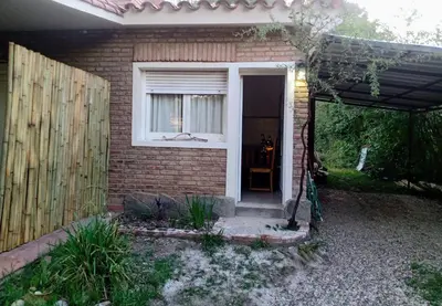 a brick house with a door and a window at Victoria in Villa Icho Cruz