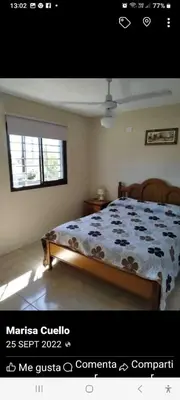 a bedroom with a bed with a comforter and a window at casa lomas in San Antonio de Arredondo