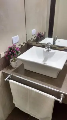 a bathroom with a white sink and a mirror at casa lomas in San Antonio de Arredondo