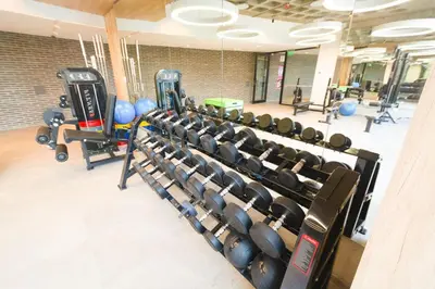 a gym with a row of dumbbells and weights at Departamento de lujo frente al quality espacio in Cordoba