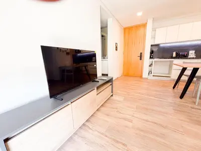 a living room with a large flat screen tv on a wall at Departamento de lujo frente al quality espacio in Cordoba