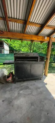 a large grill sitting inside of a building at Casa privada con piscina Potrero de Garay in Potrero de Garay