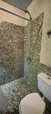 a bathroom with a shower and a toilet in it at Casa privada con piscina Potrero de Garay in Potrero de Garay