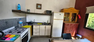 a kitchen with a white refrigerator and a stove at Casa privada con piscina Potrero de Garay in Potrero de Garay