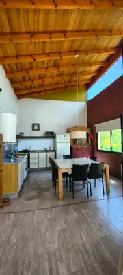 a kitchen with a table and chairs in a room at Casa privada con piscina Potrero de Garay in Potrero de Garay