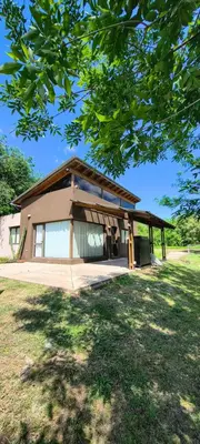 a small house with a roof on top of a yard at Casa privada con piscina Potrero de Garay in Potrero de Garay