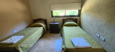 a room with three beds in it with a window at Casa privada con piscina Potrero de Garay in Potrero de Garay