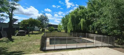 a fence around a swimming pool in a yard at Casa privada con piscina Potrero de Garay in Potrero de Garay