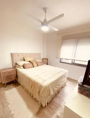 a bedroom with a large bed with a ceiling fan at Dpto Gral paz Tranquilo y comodo in Cordoba