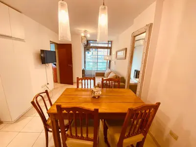 a dining room with a wooden table and chairs at Dpto Gral paz Tranquilo y comodo in Cordoba