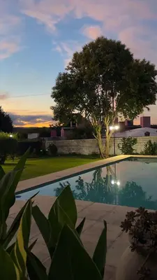 a villa with a swimming pool at dusk at Casa Simaldo in Villa Carlos Paz