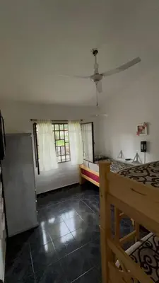 a room with a bed and a ceiling fan at Casa Simaldo in Villa Carlos Paz
