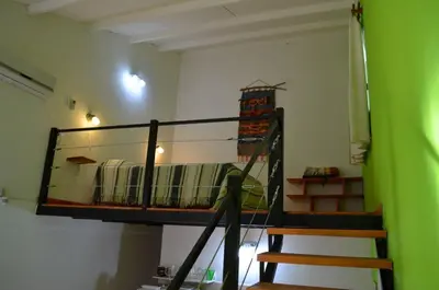 a room with a bunk bed and a staircase at Cabañas Likankurá in Santa Rosa de Calamuchita