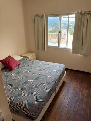 a bedroom with a bed and a window at Departamento con increible vista in Villa Carlos Paz