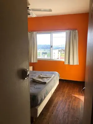 an orange room with a bed and a window at Departamento con increible vista in Villa Carlos Paz