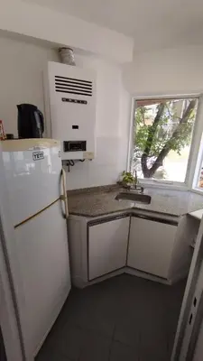 a kitchen with a white refrigerator and a sink at Departamento en Cordoba in Cordoba