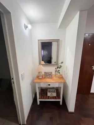 a small table in a hallway with a mirror at Departamento en Cordoba in Cordoba