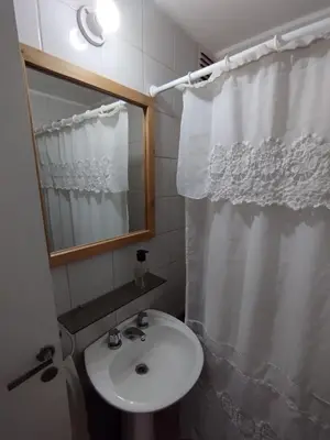 a bathroom with a sink and a shower curtain at Departamento en Cordoba in Cordoba
