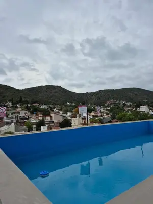 a view of a city from a swimming pool at Temporario Carlos Paz in Villa Carlos Paz