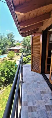 a balcony of a house with a wooden roof at ANELE, duplex equipado in Villa Carlos Paz