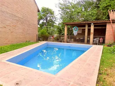 a swimming pool in the backyard of a house at ANELE, duplex equipado in Villa Carlos Paz