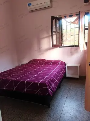 a purple bed in a room with a window at La Casita de Felipe in Santa Rosa de Calamuchita