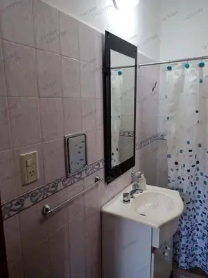a bathroom with a sink and a mirror at La Casita de Felipe in Santa Rosa de Calamuchita