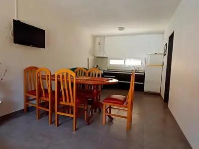 a kitchen and dining room with a table and chairs at Lisandro in Villa Carlos Paz