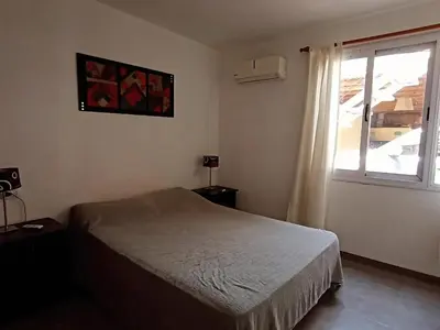 a bedroom with a bed and a window at Lisandro in Villa Carlos Paz