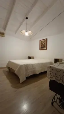 a large white room with a large bed in it at Lisandro in Villa Carlos Paz