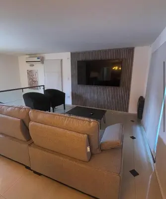 a living room with a couch and a table at CASA LG carlos paz in Villa Carlos Paz