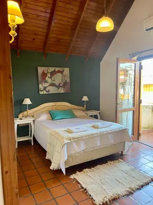 a bedroom with a bed and two nightstands at Posada Novalis in Villa General Belgrano