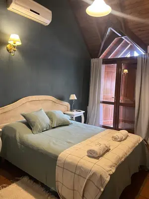 a bedroom with a large bed with towels on it at Posada Novalis in Villa General Belgrano