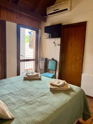 a bedroom with a bed with two towels on it at Posada Novalis in Villa General Belgrano