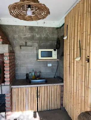 a kitchen with a sink and a microwave at Cobiche in Villa Larca