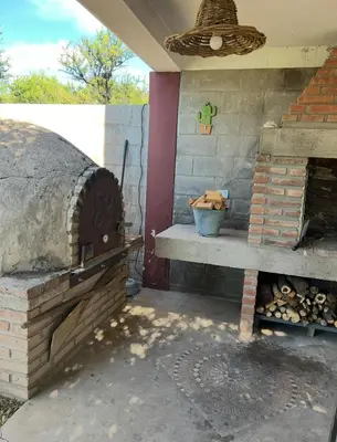 an outdoor brick oven with a basket on top at Cobiche in Villa Larca
