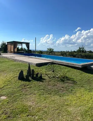 a swimming pool with a wheel in front of it at Cobiche in Villa Larca