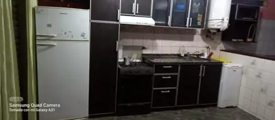 a kitchen with a white refrigerator and a stove at casa carlos paz in Villa Carlos Paz