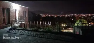 a balcony of a building with a view of a city at night at casa carlos paz in Villa Carlos Paz