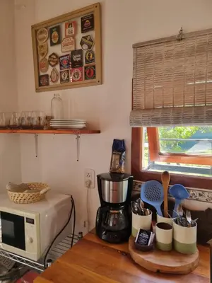 a kitchen with a coffee maker and a microwave at Casitas Santa Elena in Trapiche