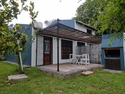 a small blue and white house with a table and chairs at Casitas Santa Elena in Trapiche
