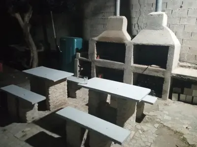 a group of picnic tables and a brick oven at Las Vertientes in Tanti