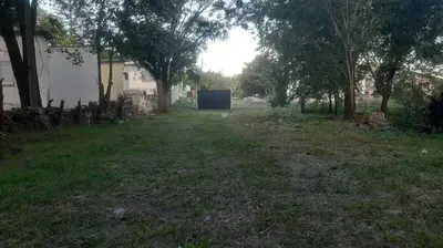 an empty yard with trees and a building at Las Vertientes in Tanti
