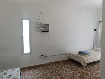a white room with a bed and a window at Las Vertientes in Tanti